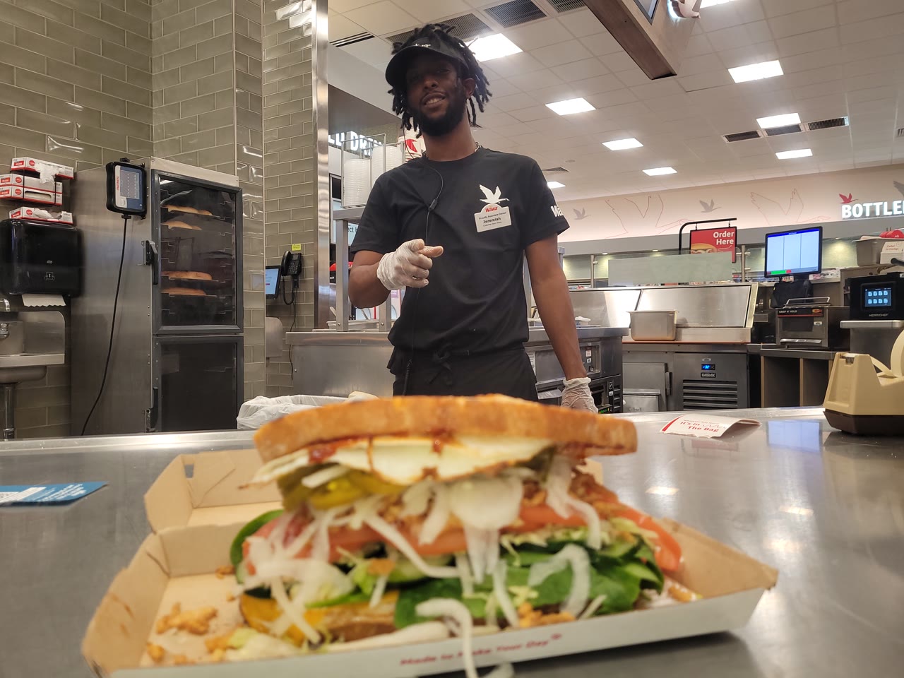 Jeremiah at Wawa Davie building an overloaded panini with topping festival bag hack