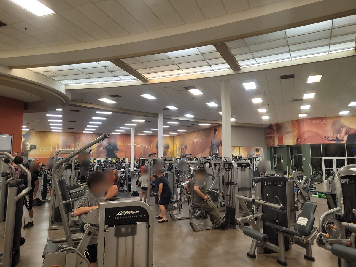 Wide view of the machine floor at LA Fitness Hollywood FL with rows of strength machines